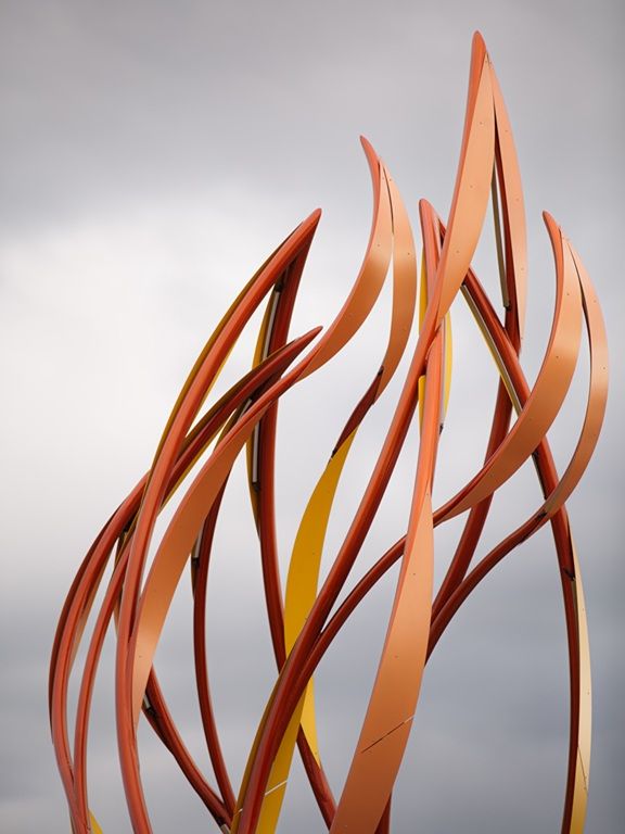 Close up image of top of curved steel sculpture "Be the Light" by Curtis Pittman